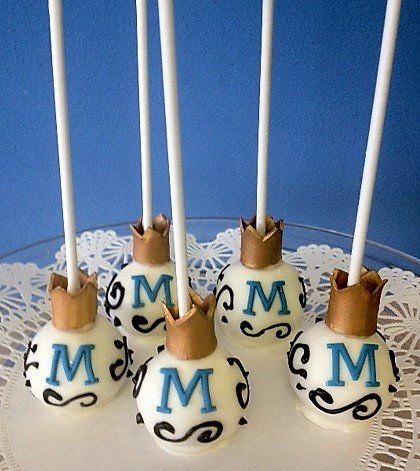 A bunch of cake pops with the letter m on them