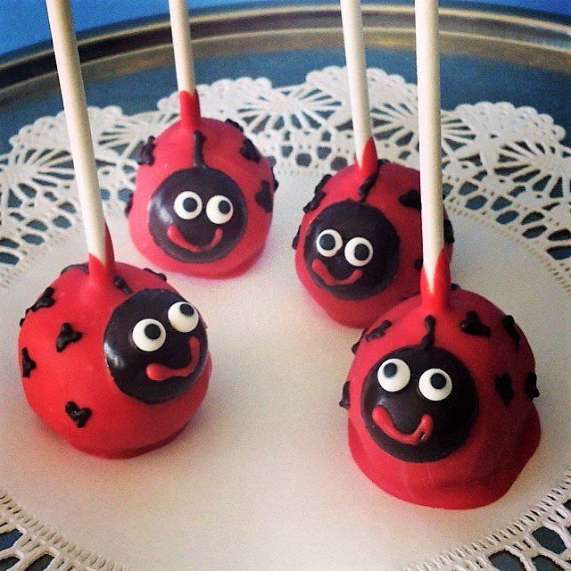 A bunch of ladybug cake pops on a tray
