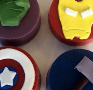 Four soaps with a hulk , iron man , captain america and thor on them