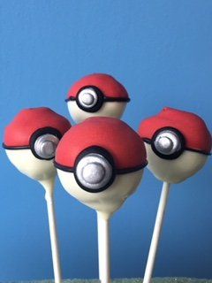 Four pokemon cake pops are sitting on a table