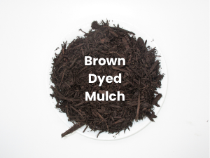 A pile of brown dyed mulch on a white surface