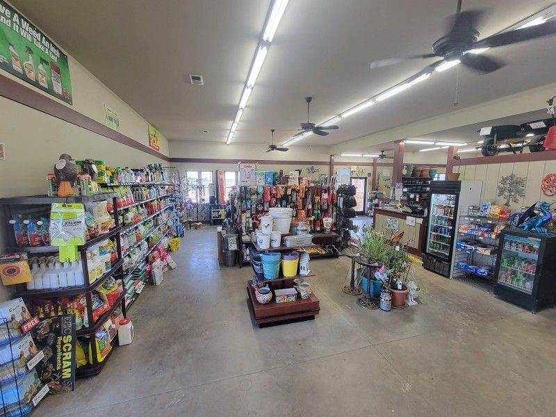 A grocery store filled with lots of shelves and a ceiling fan.