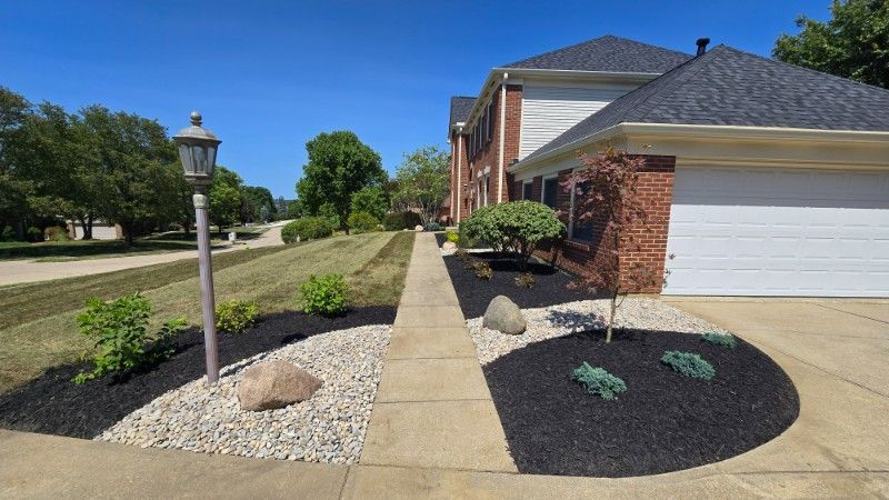 A house with a white garage door and a walkway leading to it