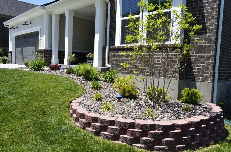 A brick house with a garden in front of it
