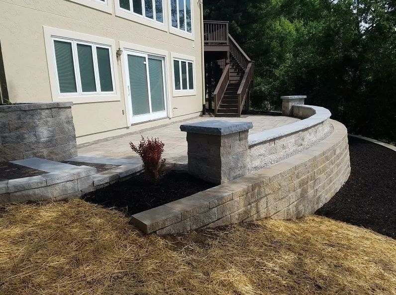 A large house with a patio and stairs in front of it.