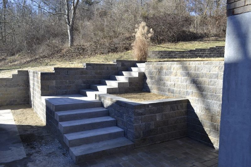 A set of stairs leading up to a brick wall