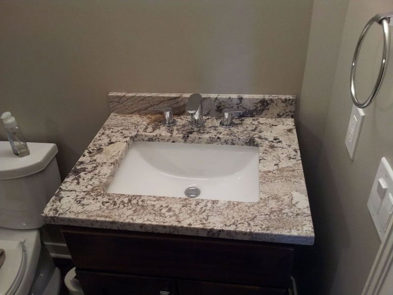 A bathroom with a sink and toilet in it