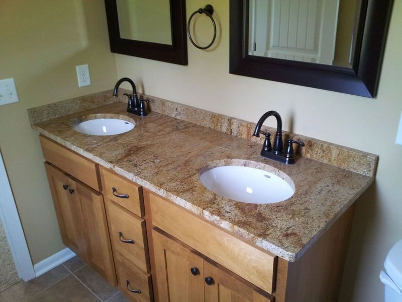 A bathroom with two sinks and two mirrors