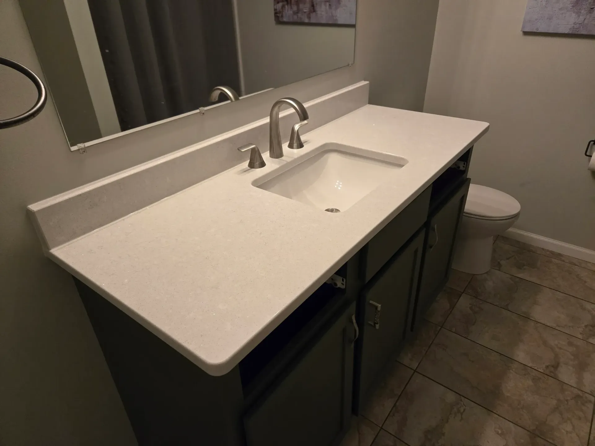 A bathroom with a sink , toilet and mirror