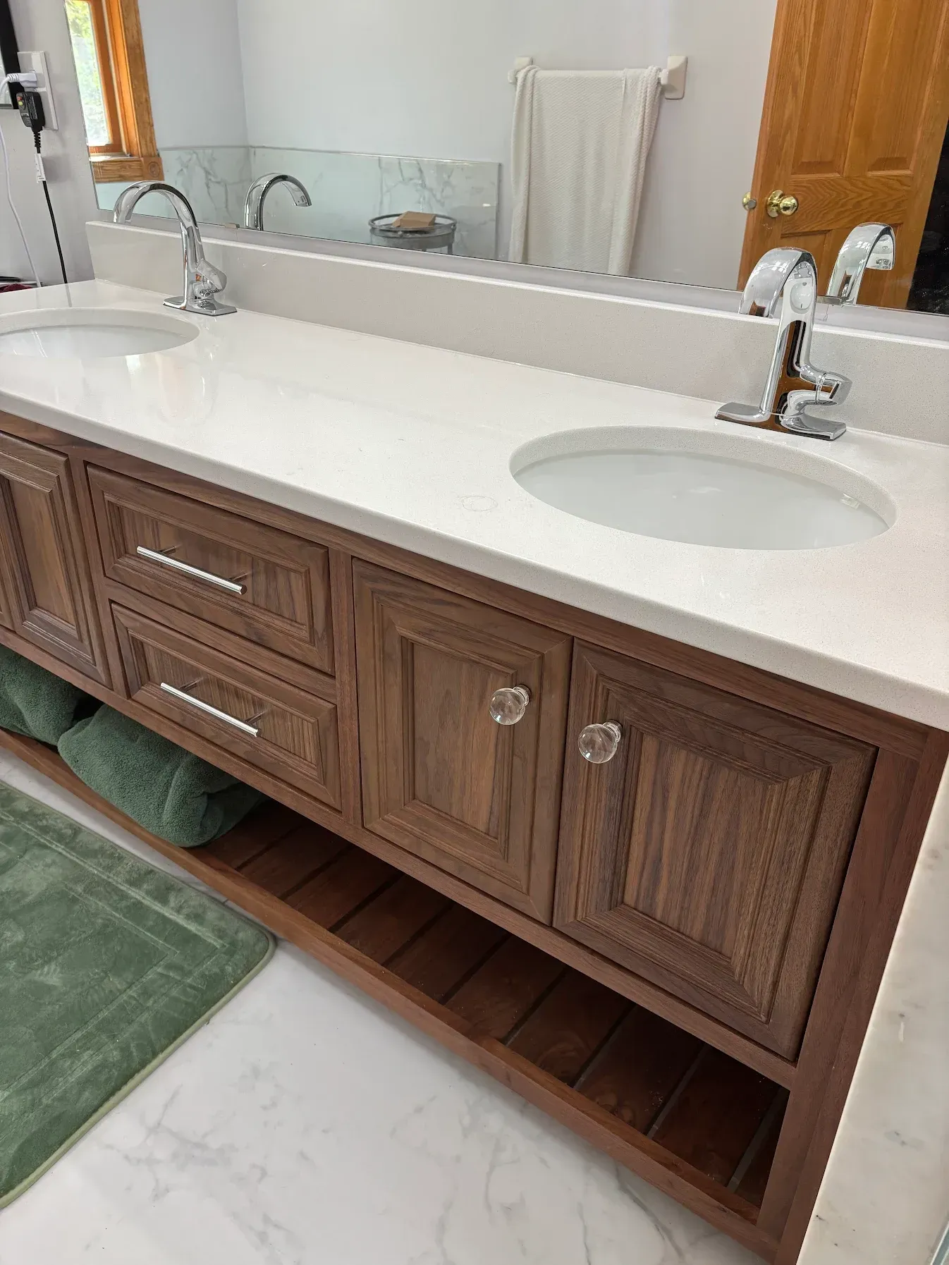 A bathroom with two sinks and a large mirror.