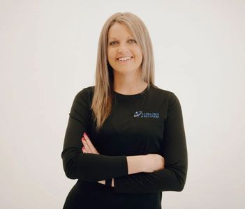 A woman wearing a black shirt with the word jenny on it