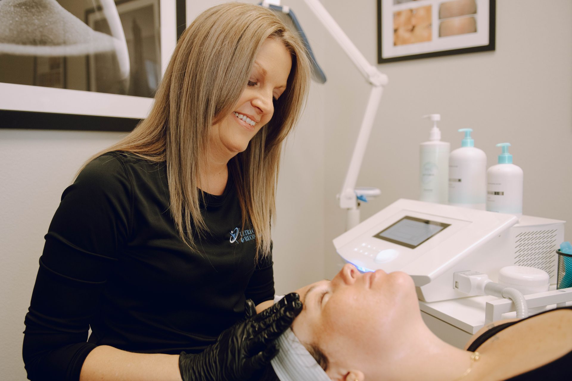 A woman is giving a woman a facial treatment in a beauty salon.