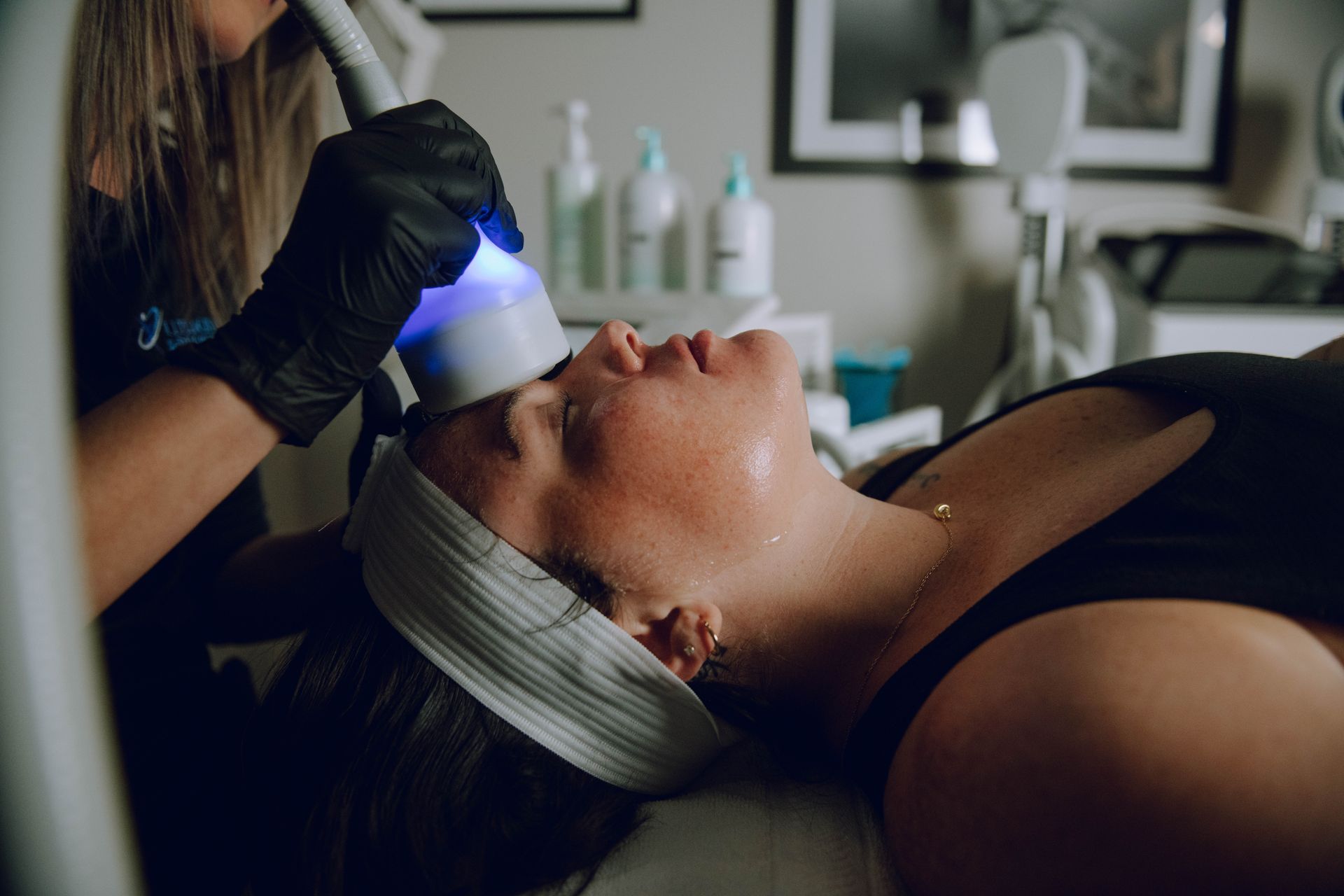 A woman is getting a facial treatment at a beauty salon.