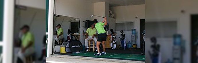 boy taking golf lessons