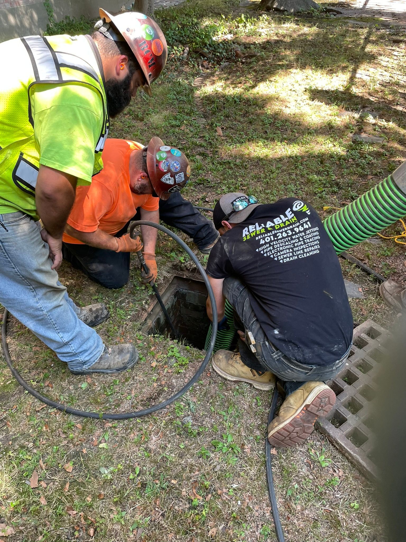 A group of men are working on a drain.