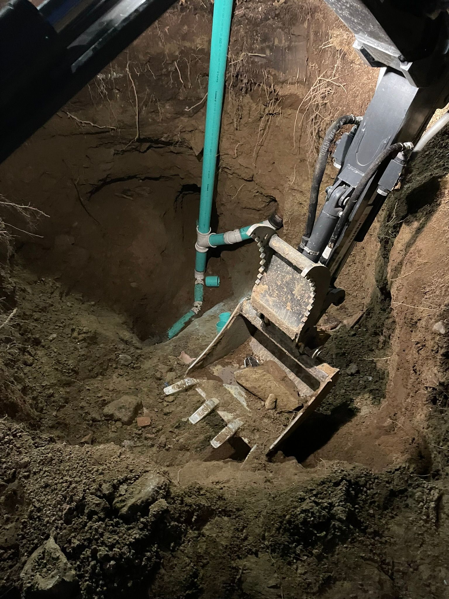 A machine is digging a hole in the ground.