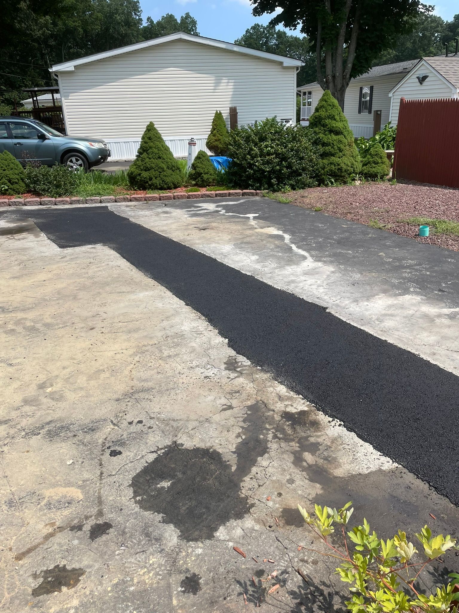 A mobile home is sitting in the middle of a parking lot.