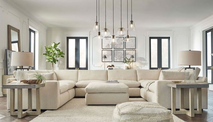 A living room filled with furniture and a large sectional couch.