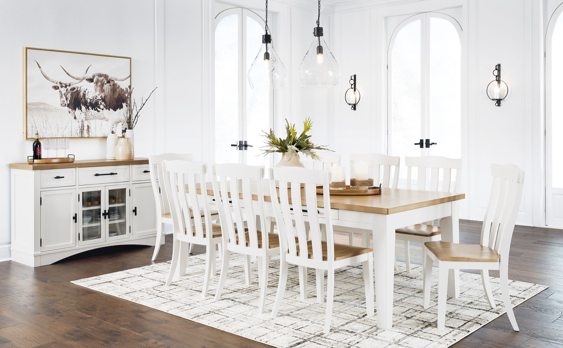 A dining room with a table and chairs and a rug.