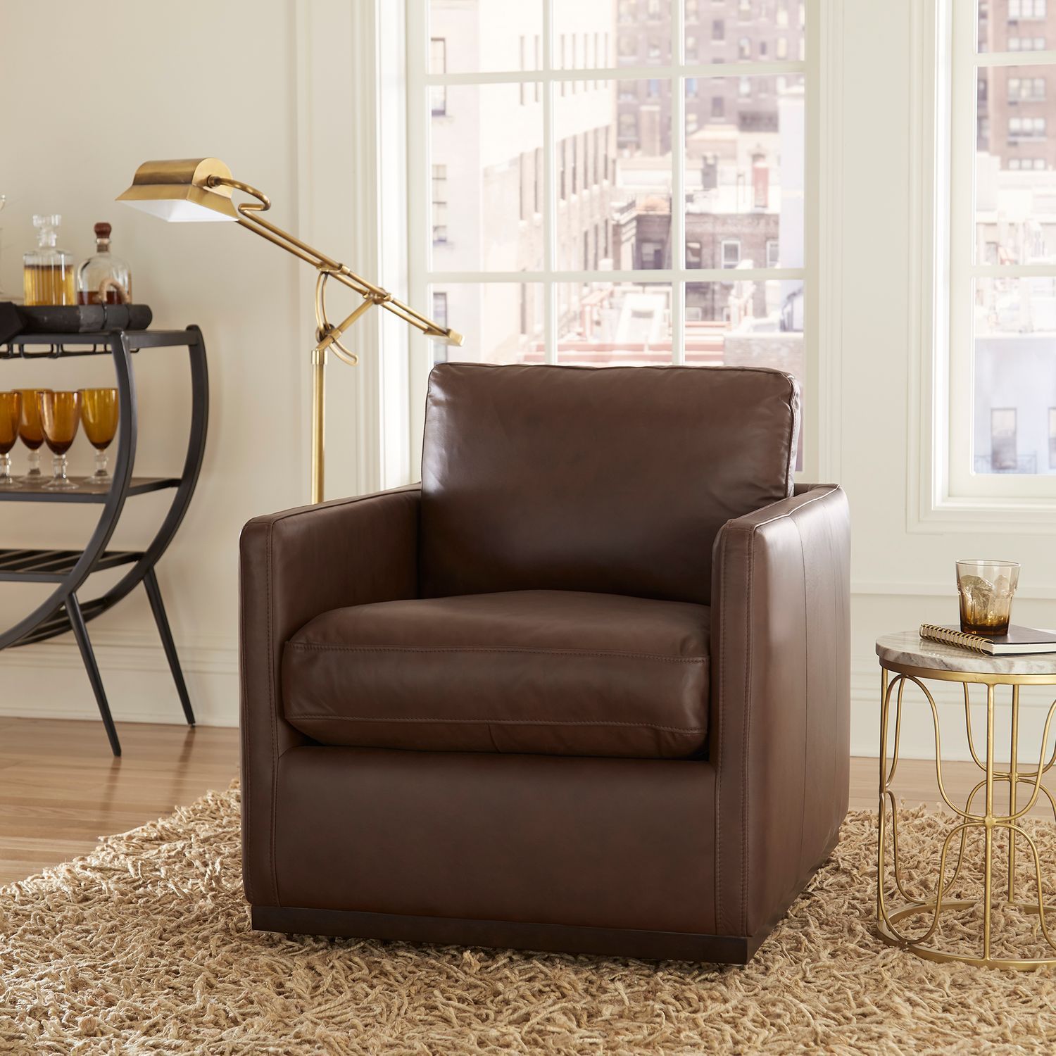 A brown leather chair is sitting on a rug in a living room