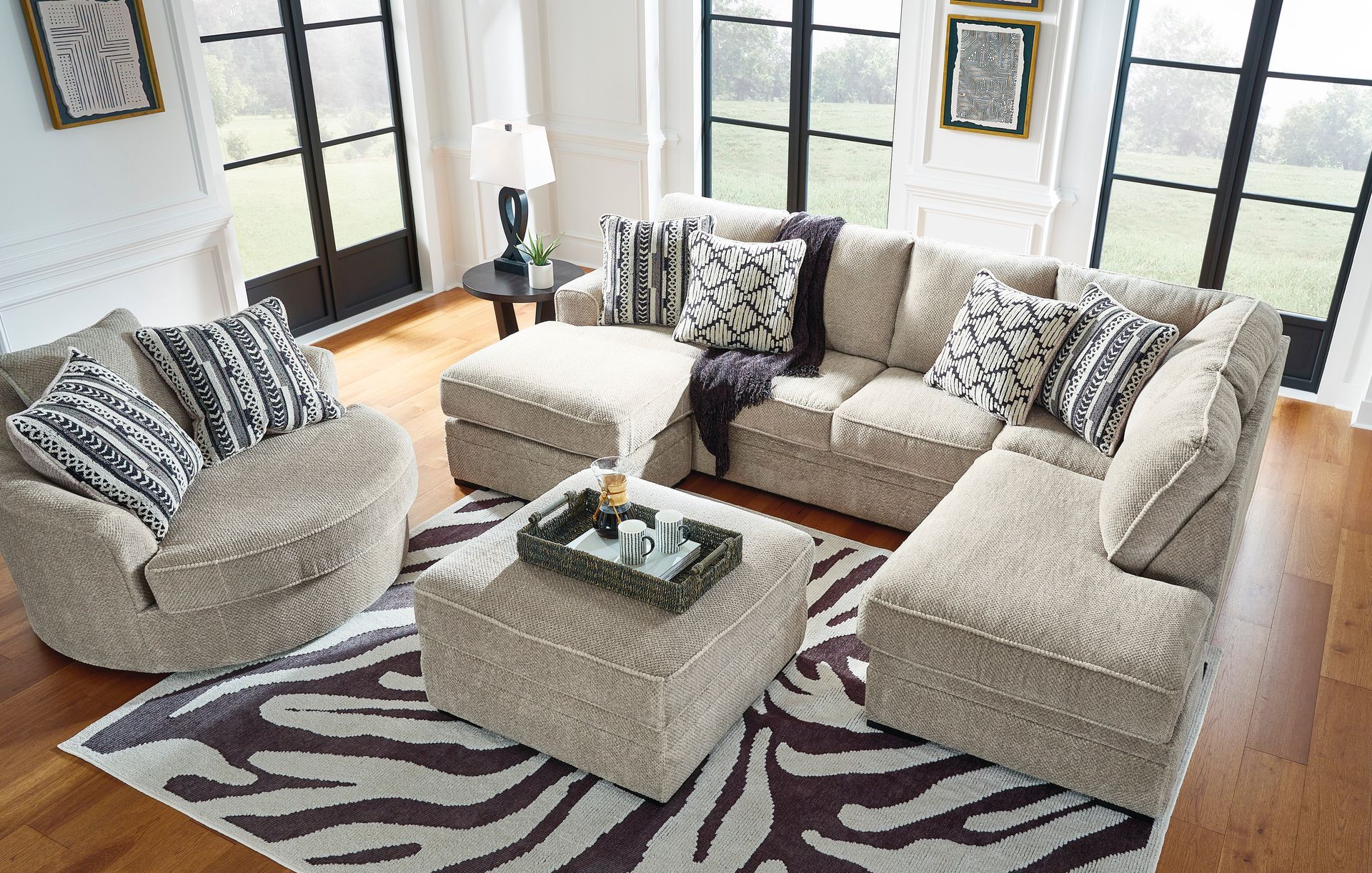 A living room filled with furniture and a zebra print rug.