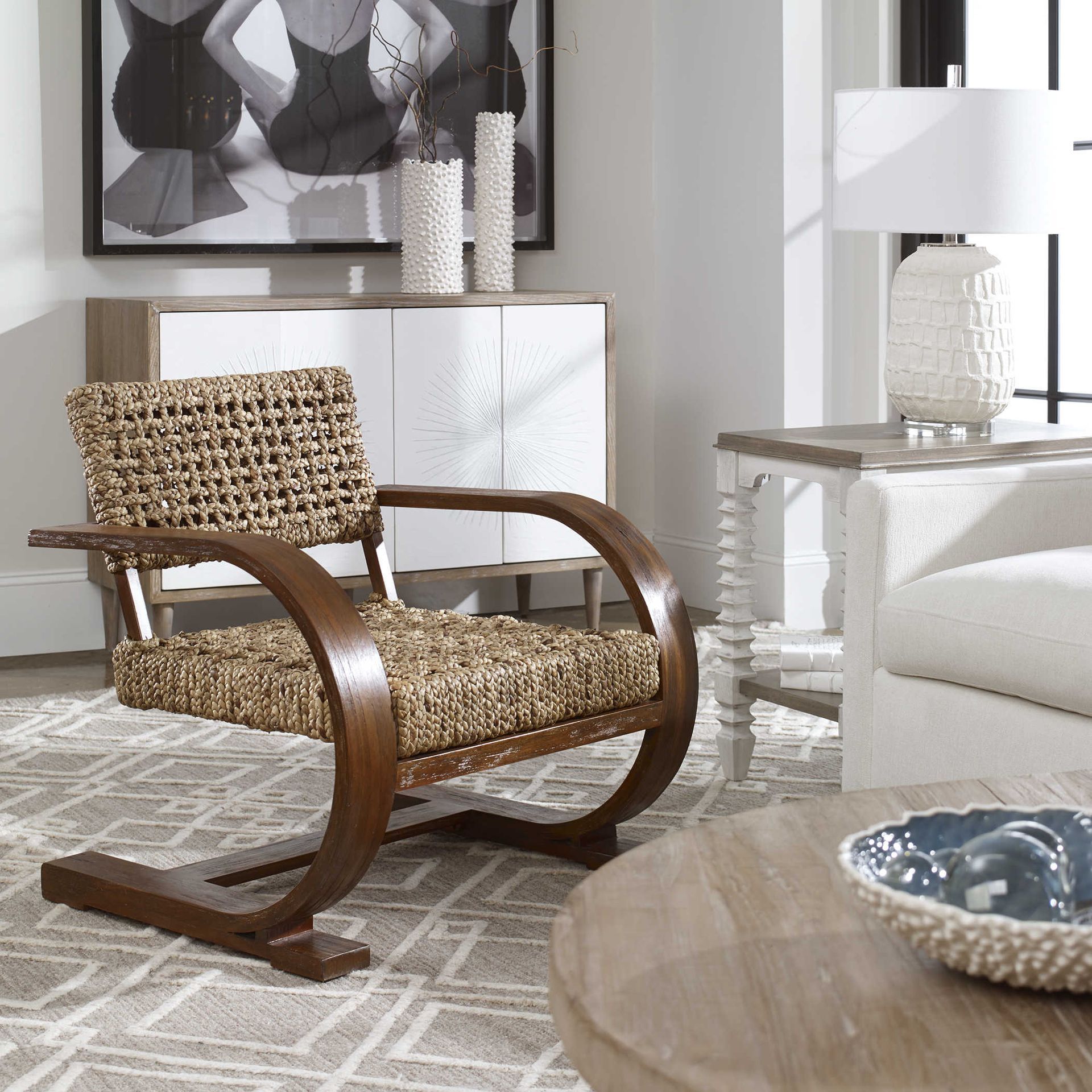 A living room with a wicker chair and a white couch