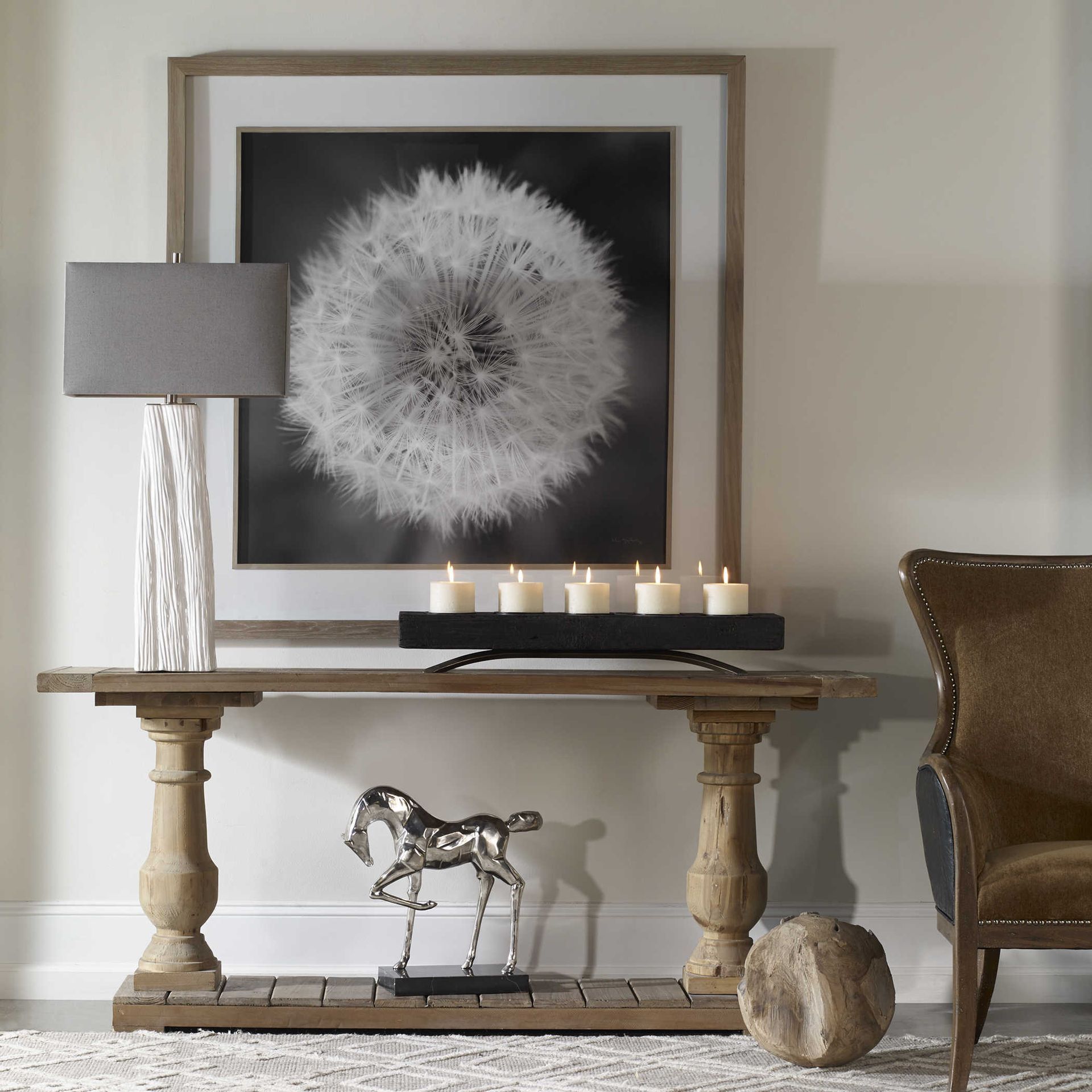 A picture of a dandelion hangs above a wooden table