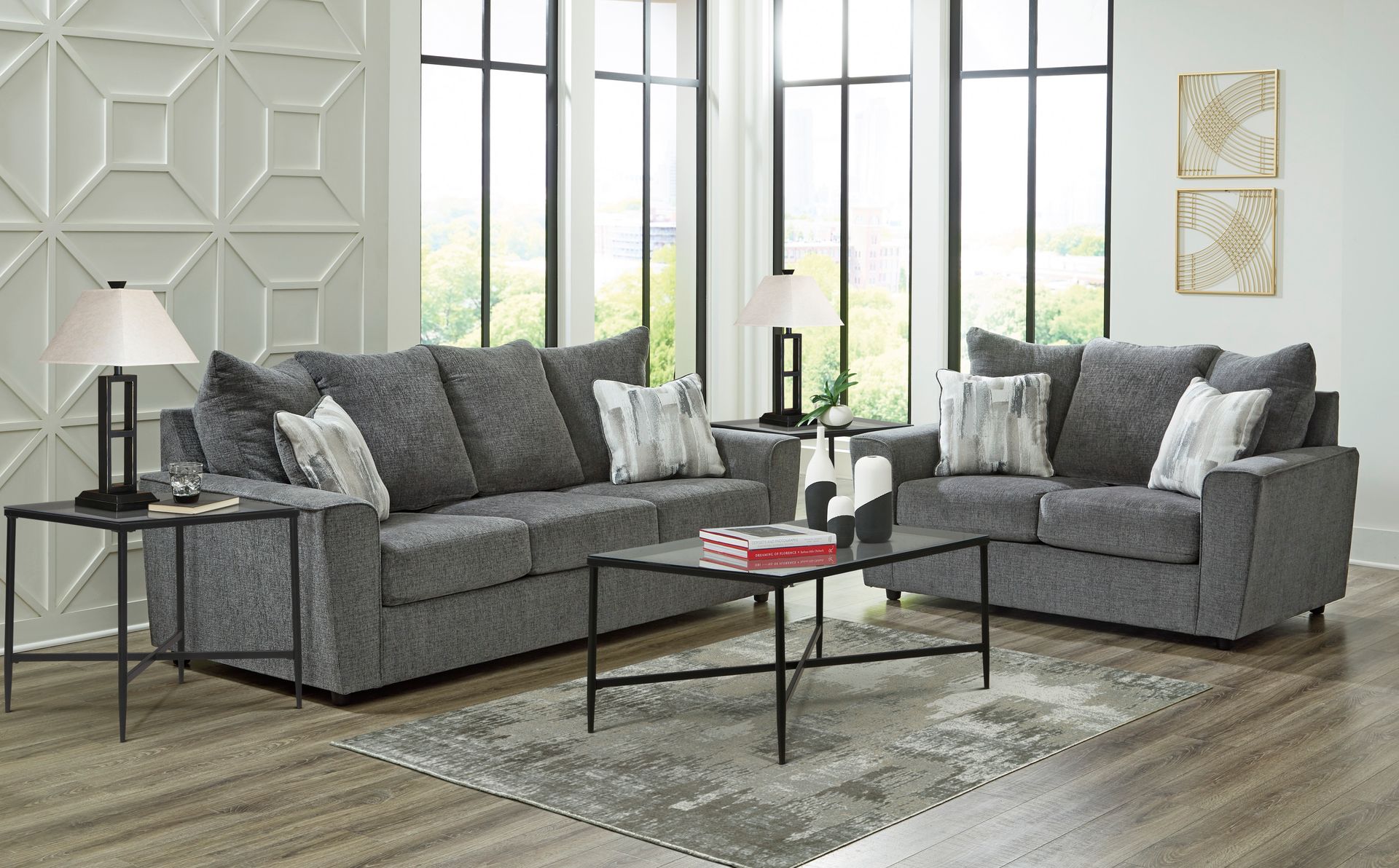 A living room with two grey couches and a coffee table.