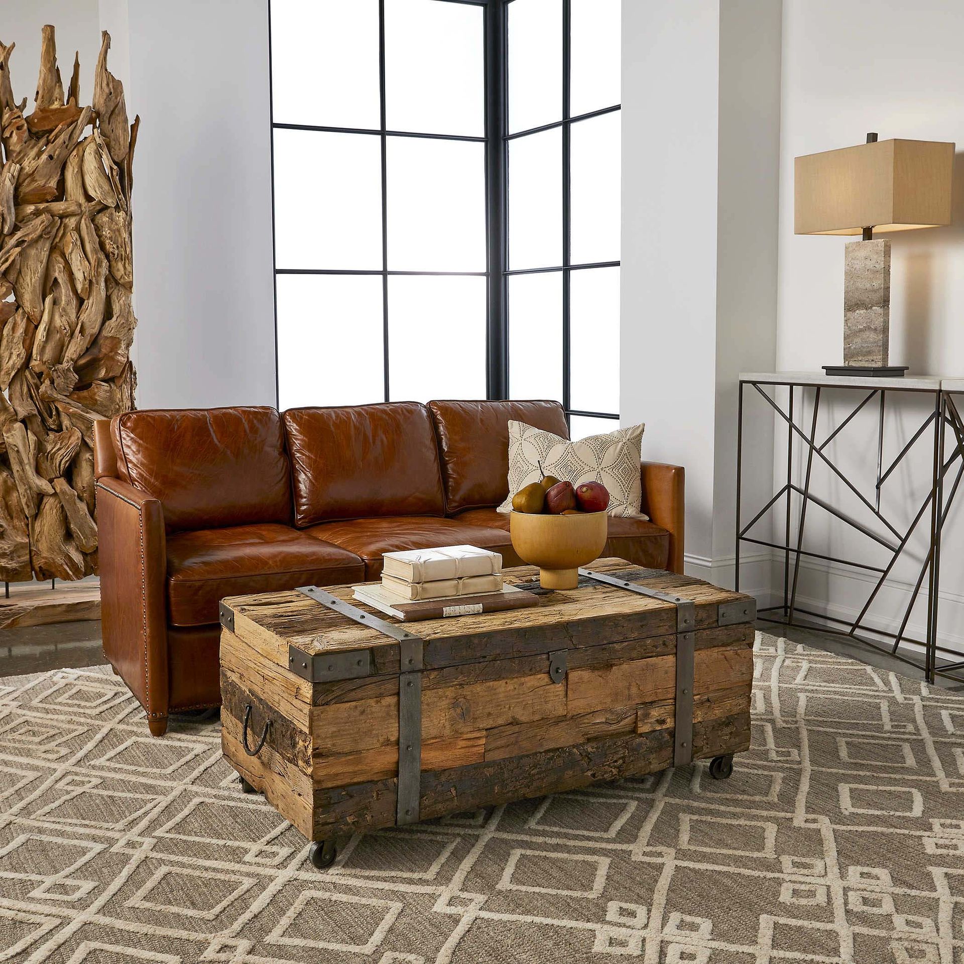 A living room with a brown leather couch and a wooden coffee table