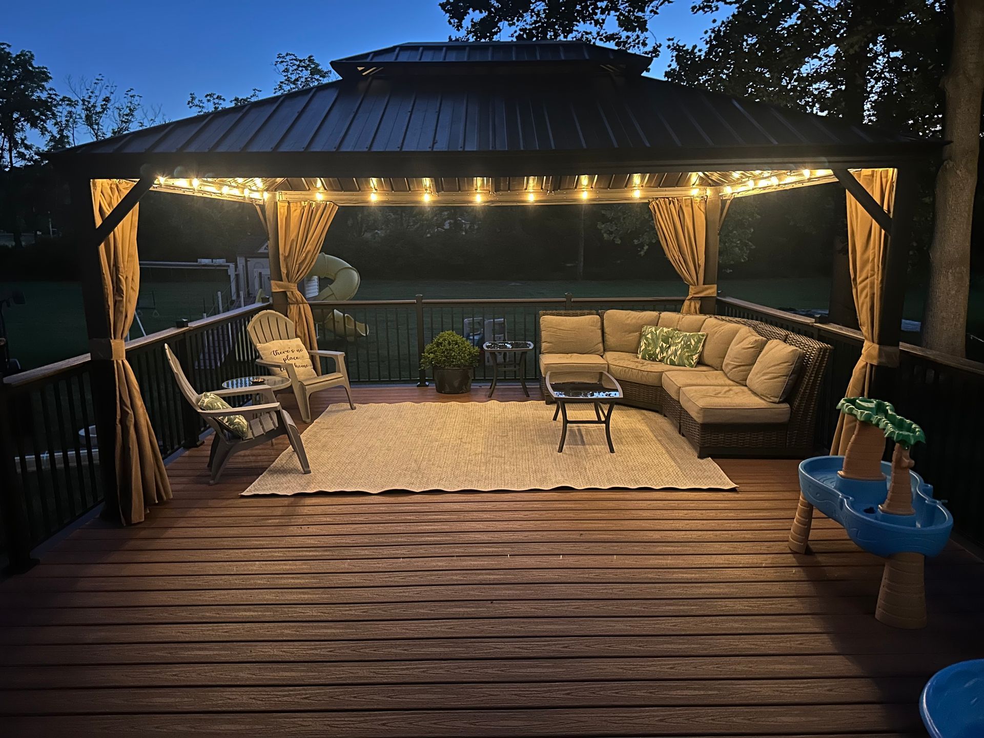 A deck at night with canopy and string lights