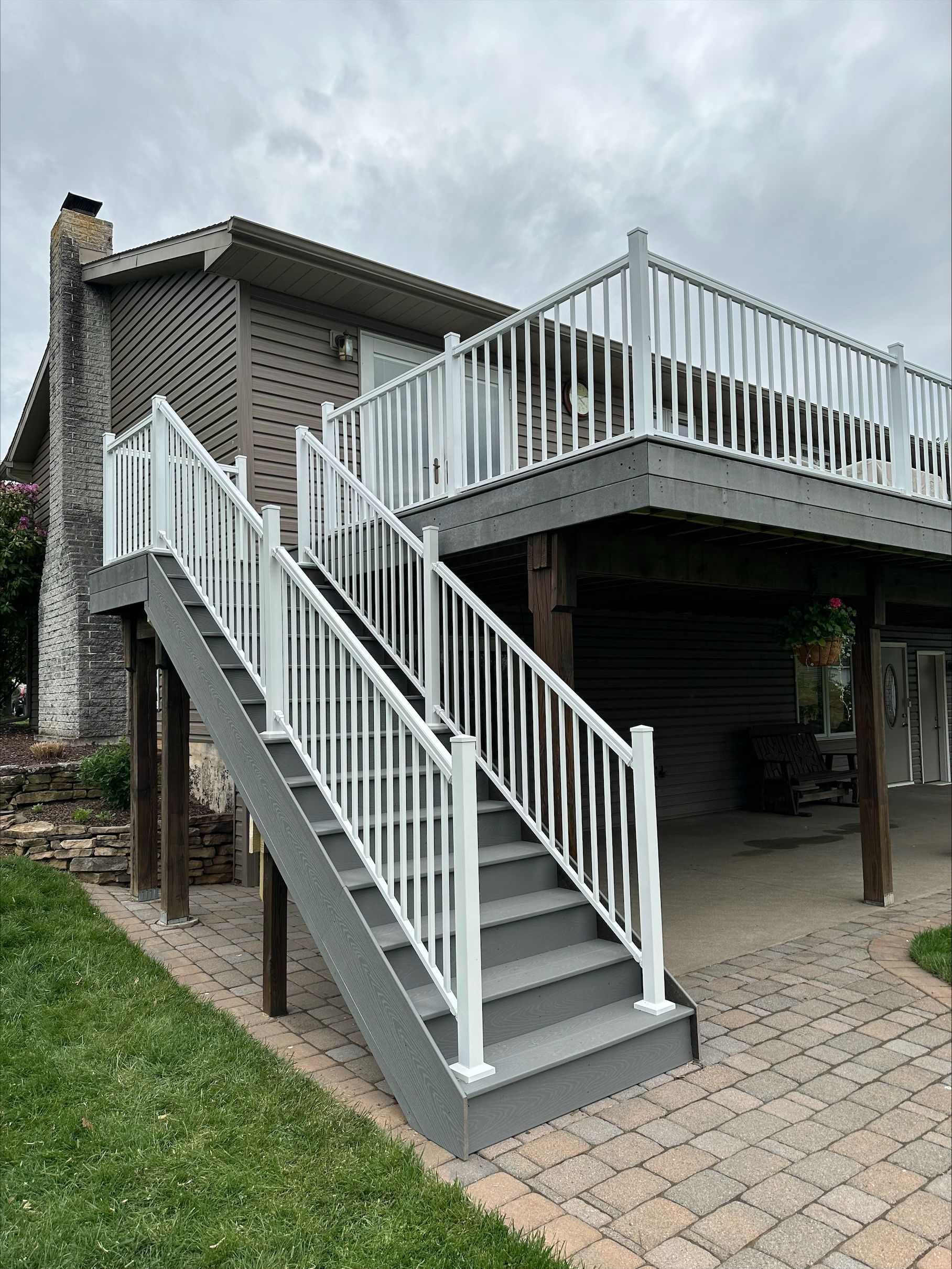 A house with a deck and stairs leading up to it.