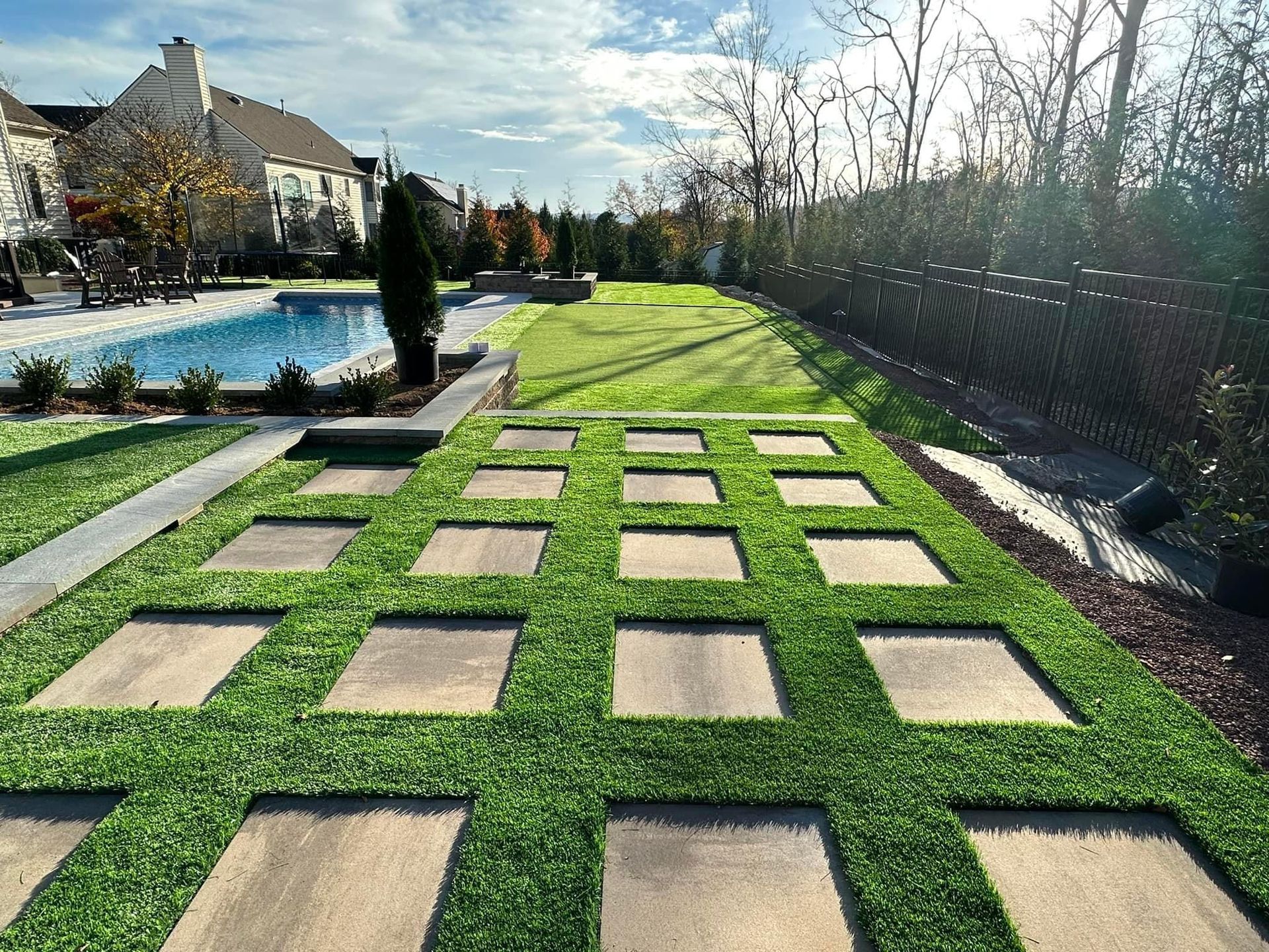 grass with square patterns and a pool in the background