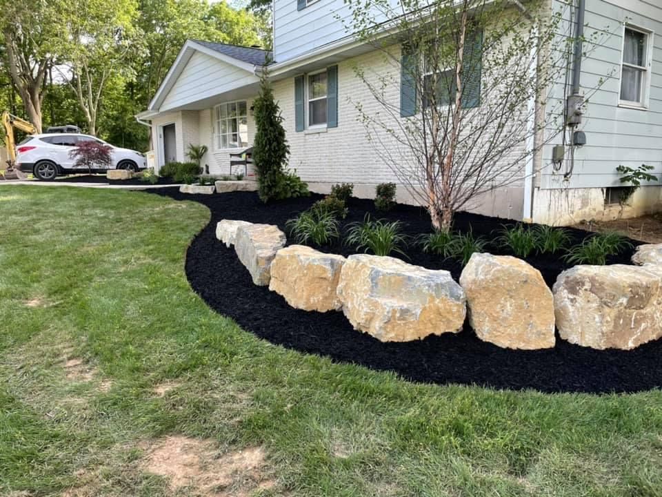 huge rocks and black soil on garden