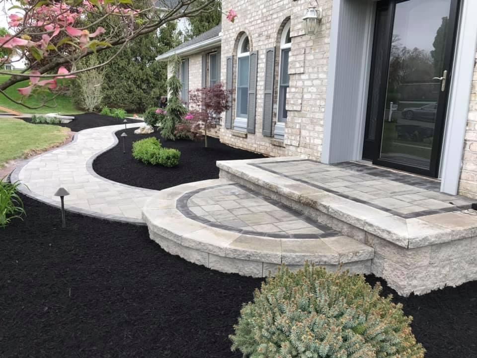 curvy white patio with black soil