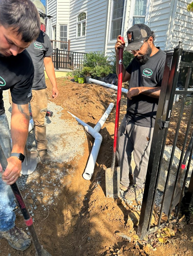 people laying out a pipe
