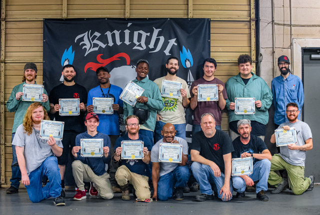 Graduates showing their certificates