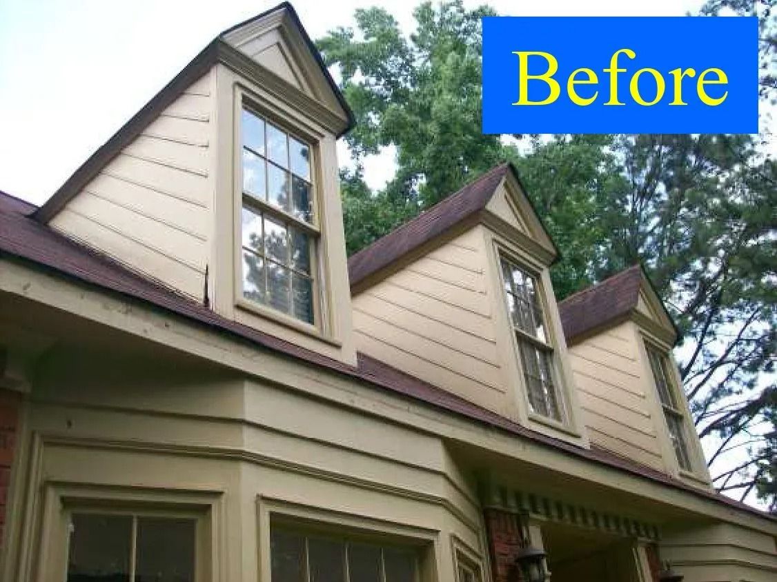Exterior view of a house with beige siding, dormer windows, and a brown roof, labeled 