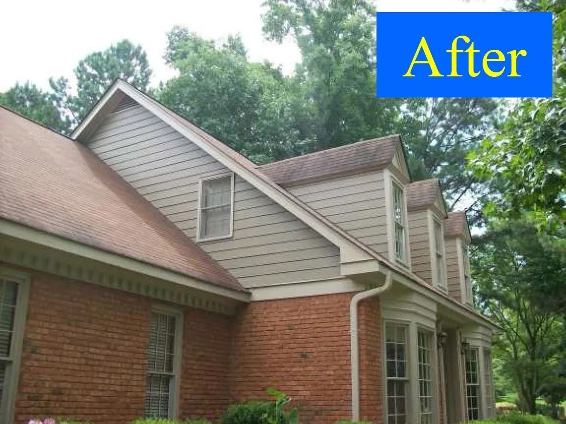 House exterior with new siding, brick, and brown roof. Blue 