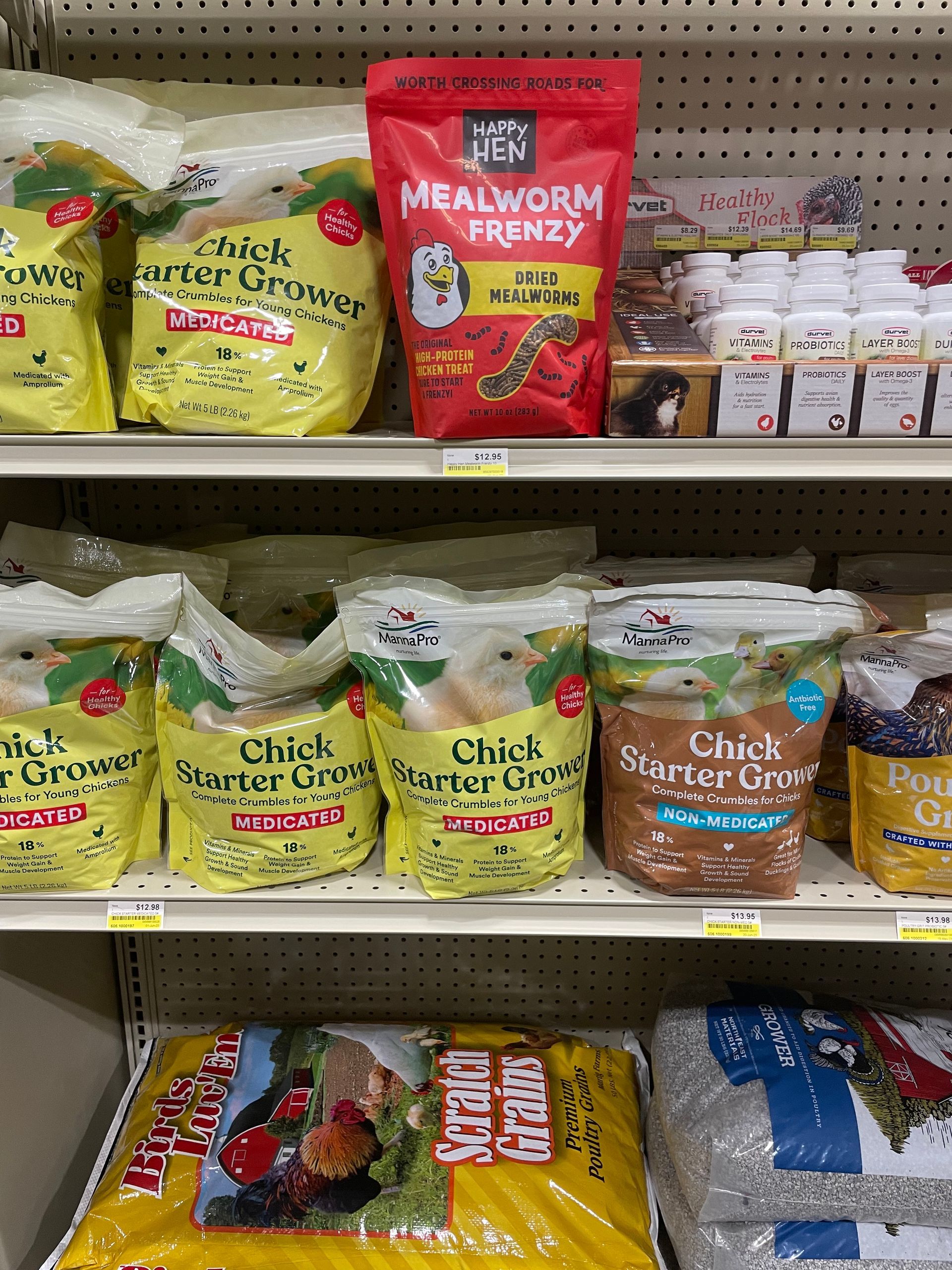 A shelf filled with bags of food, including a bag of mealworms.