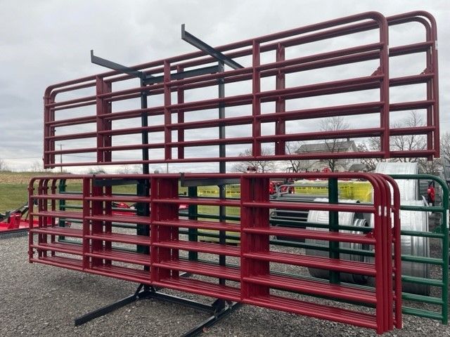 A bunch of rodeo gates are stacked on top of each other.