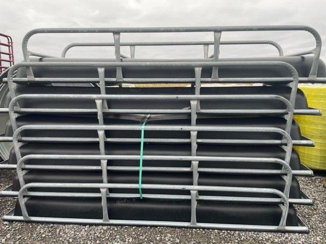 A bunch of metal fences are stacked on top of each other.