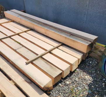 A bunch of wooden boards are stacked on top of each other.