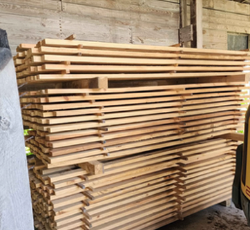 A stack of wooden boards is sitting in a warehouse.