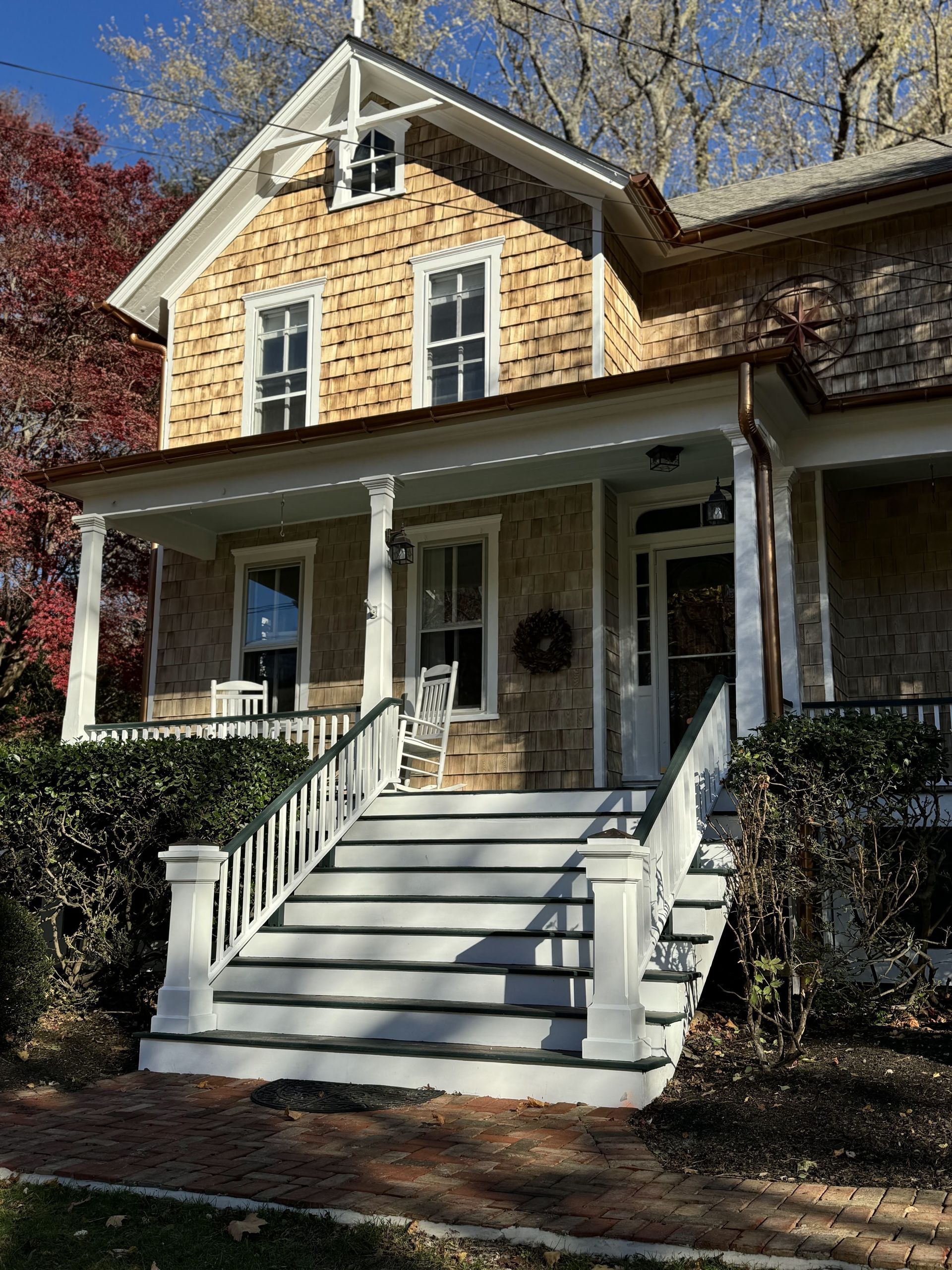 A large house with a porch and stairs