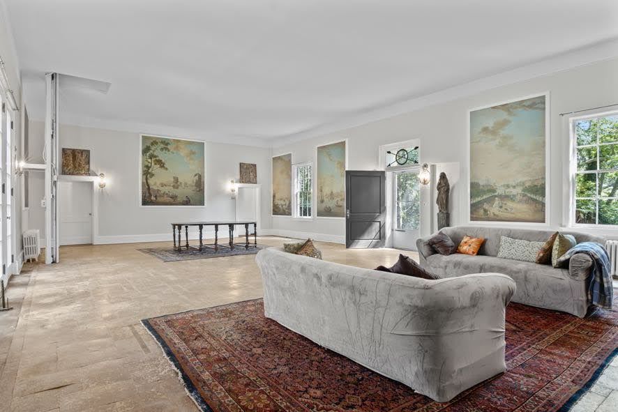 A living room with two couches and a rug.