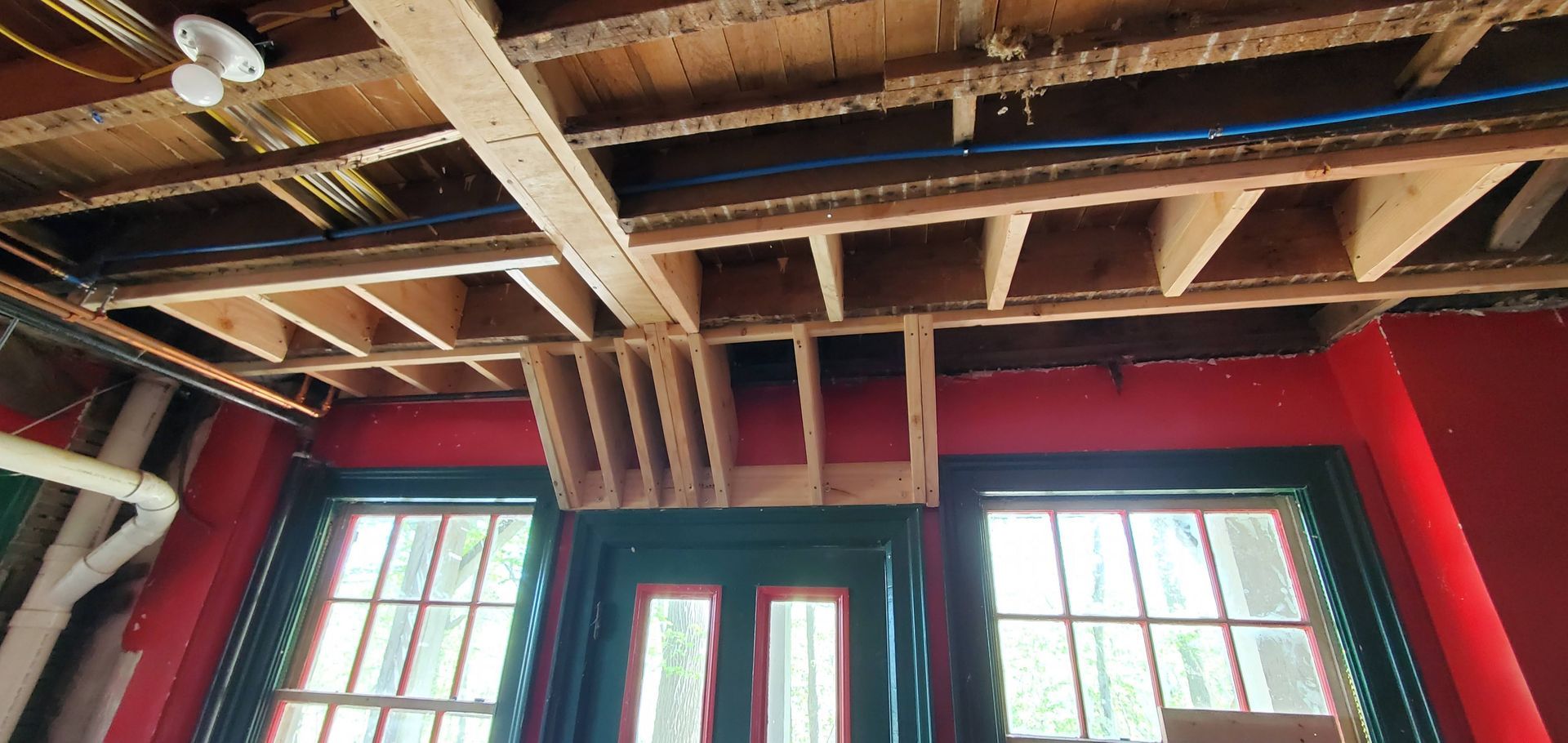 A room with red walls and a wooden ceiling.