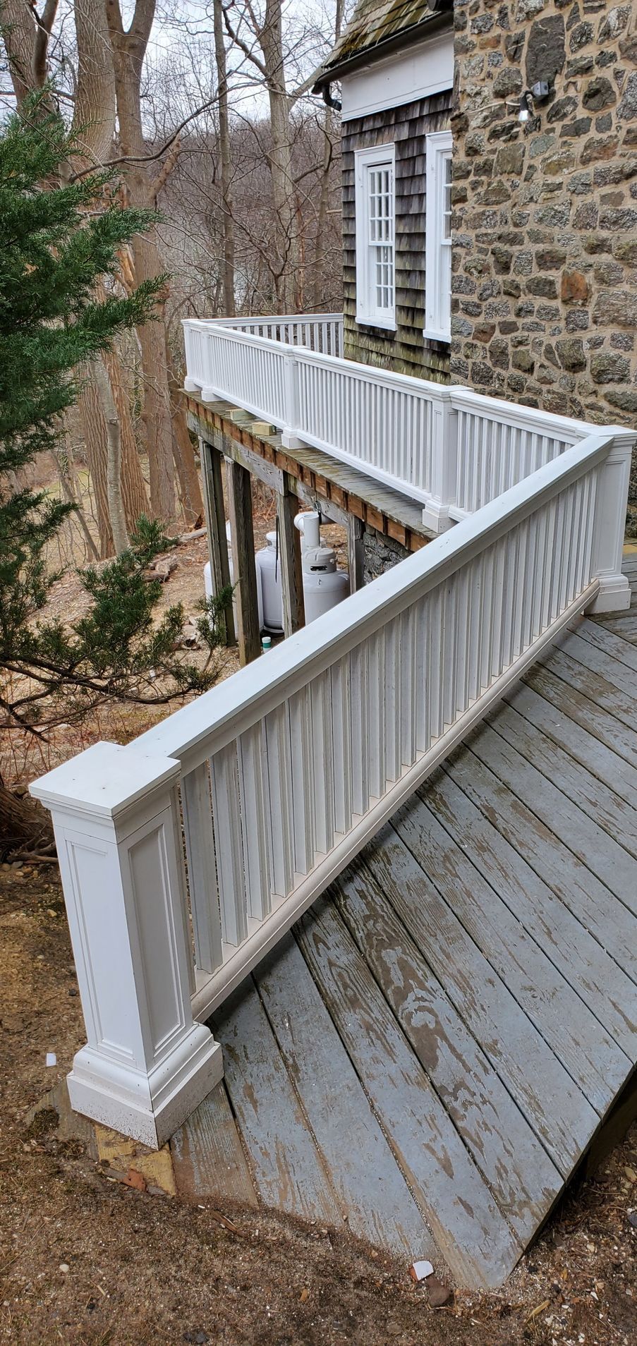 There is a ramp leading to the deck of a house.