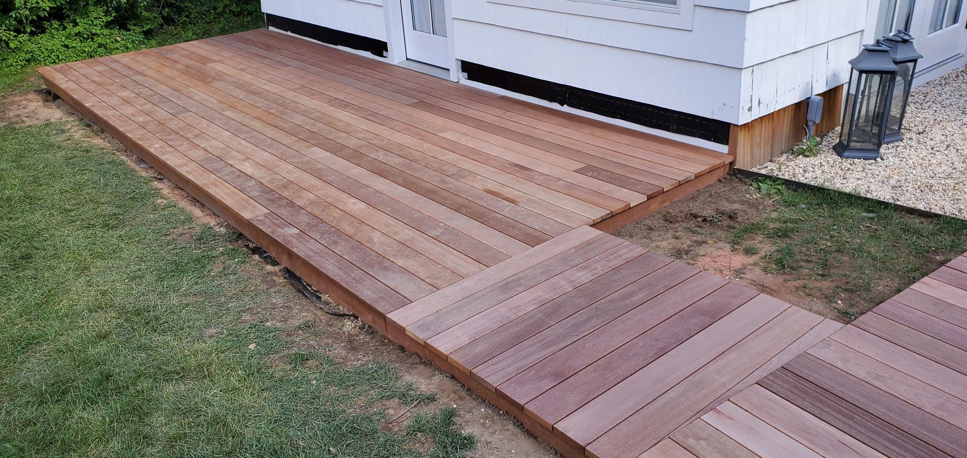 Wooden walkway leading to a white house