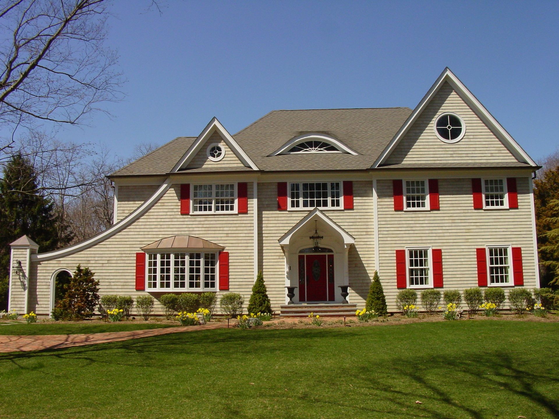 A large house with red shutters on the windows