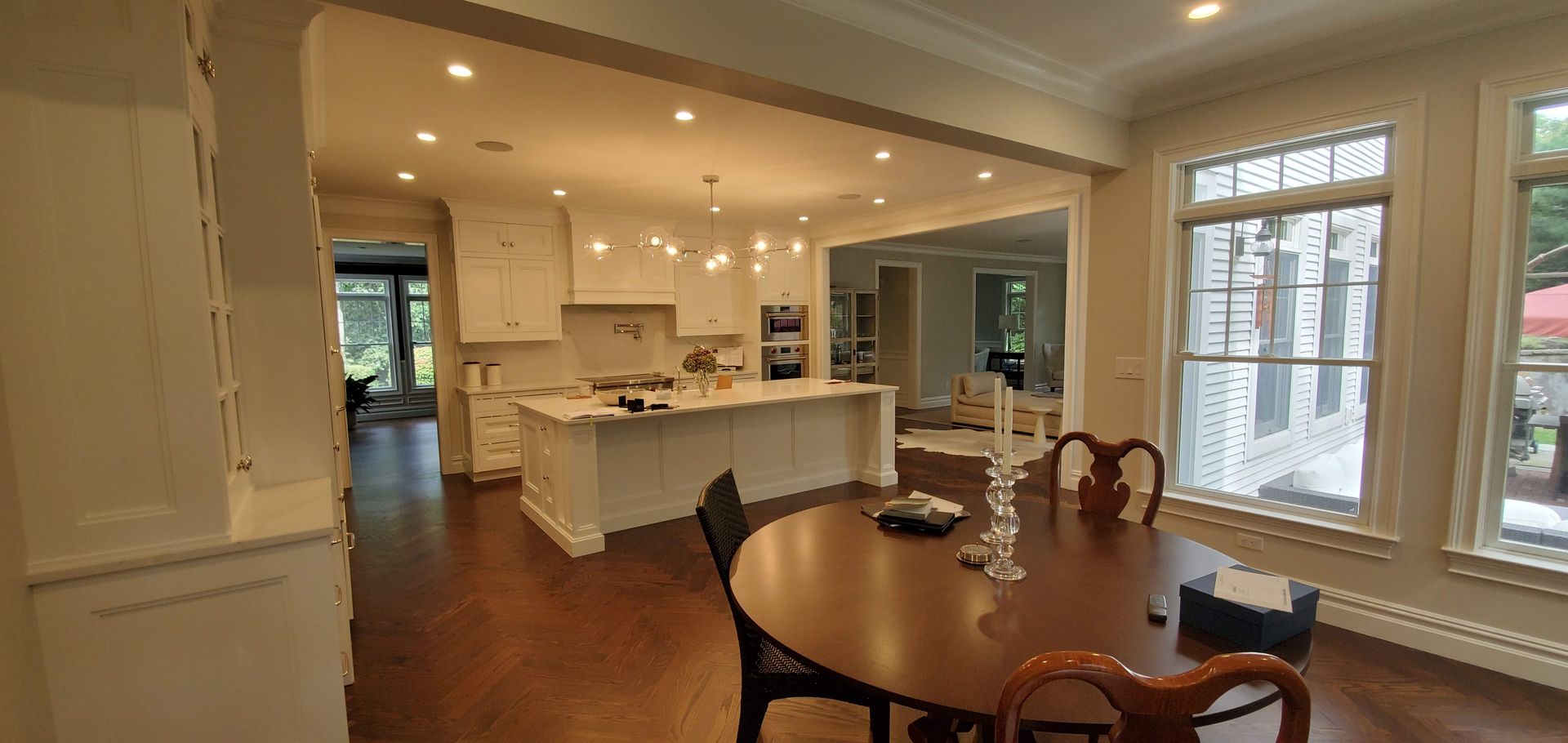A kitchen and dining room in a house with a round table and chairs